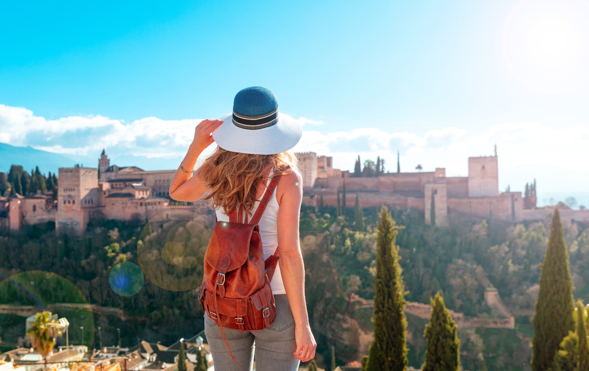 Woman tourist looking at Ancient arabic fortress Alhambra- Granada in Spain